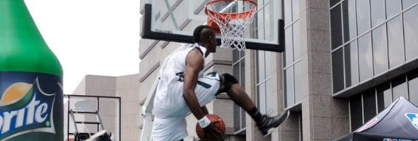 Spud Webb jumping over a kid at his - Basketball Network