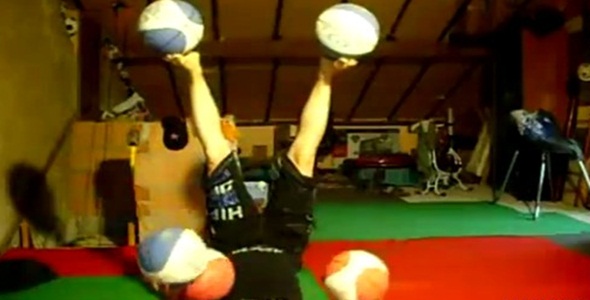 Upside Down Hippie Girl Juggles 5 Basketballs